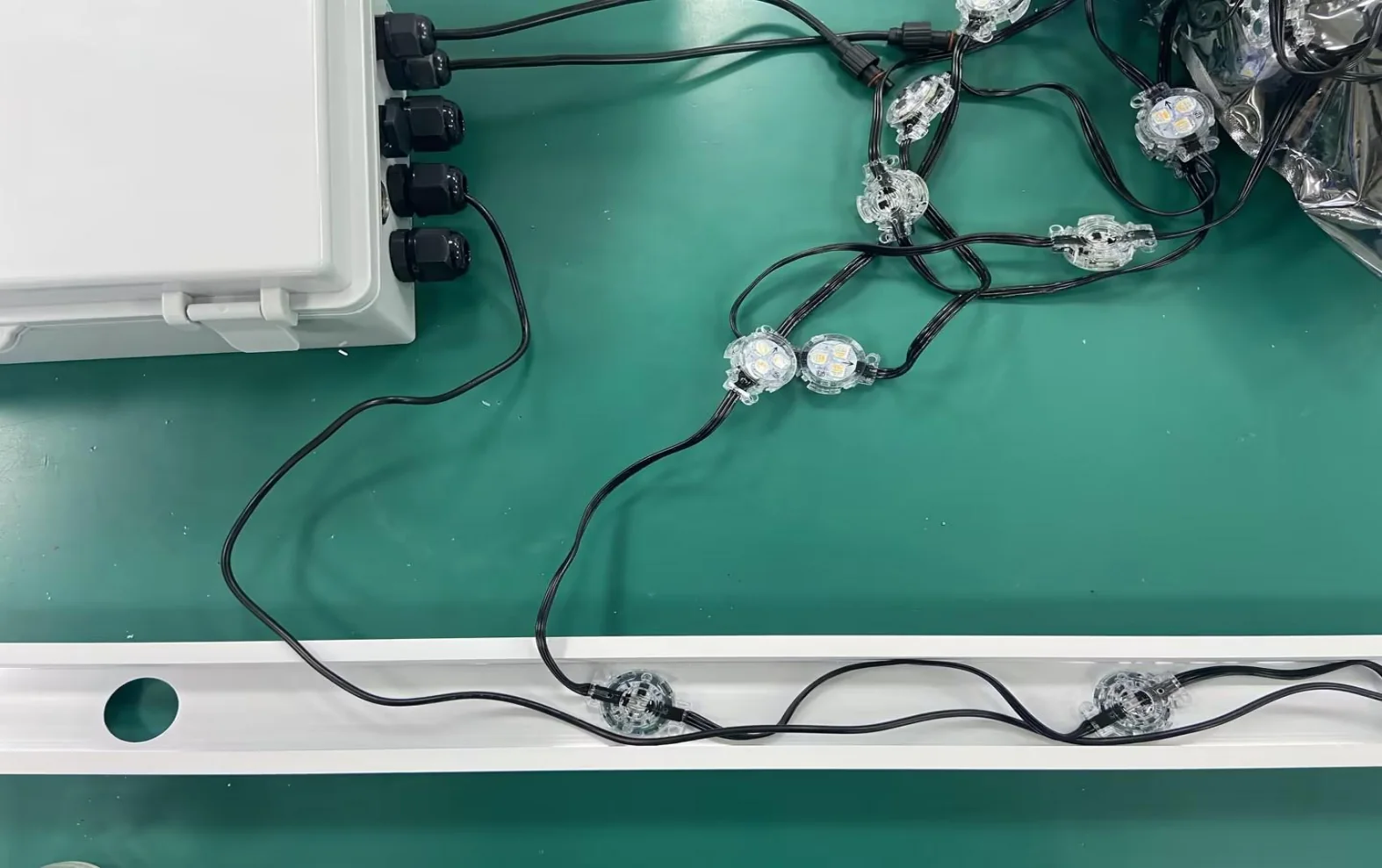 RGBW pixel lights and power cable routed toward the aluminum mounting track
