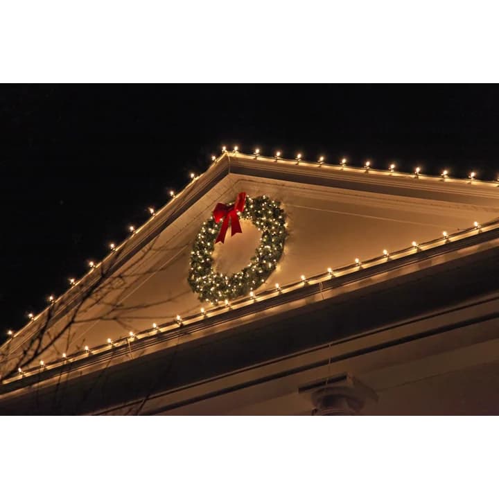 Warm white C7 LED bulbs installed along a residential roofline