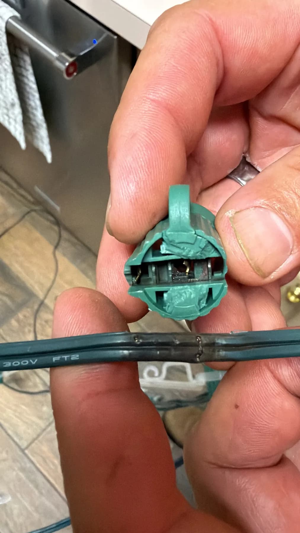 Opened C9 light-line socket showing internal contacts and flat wire
