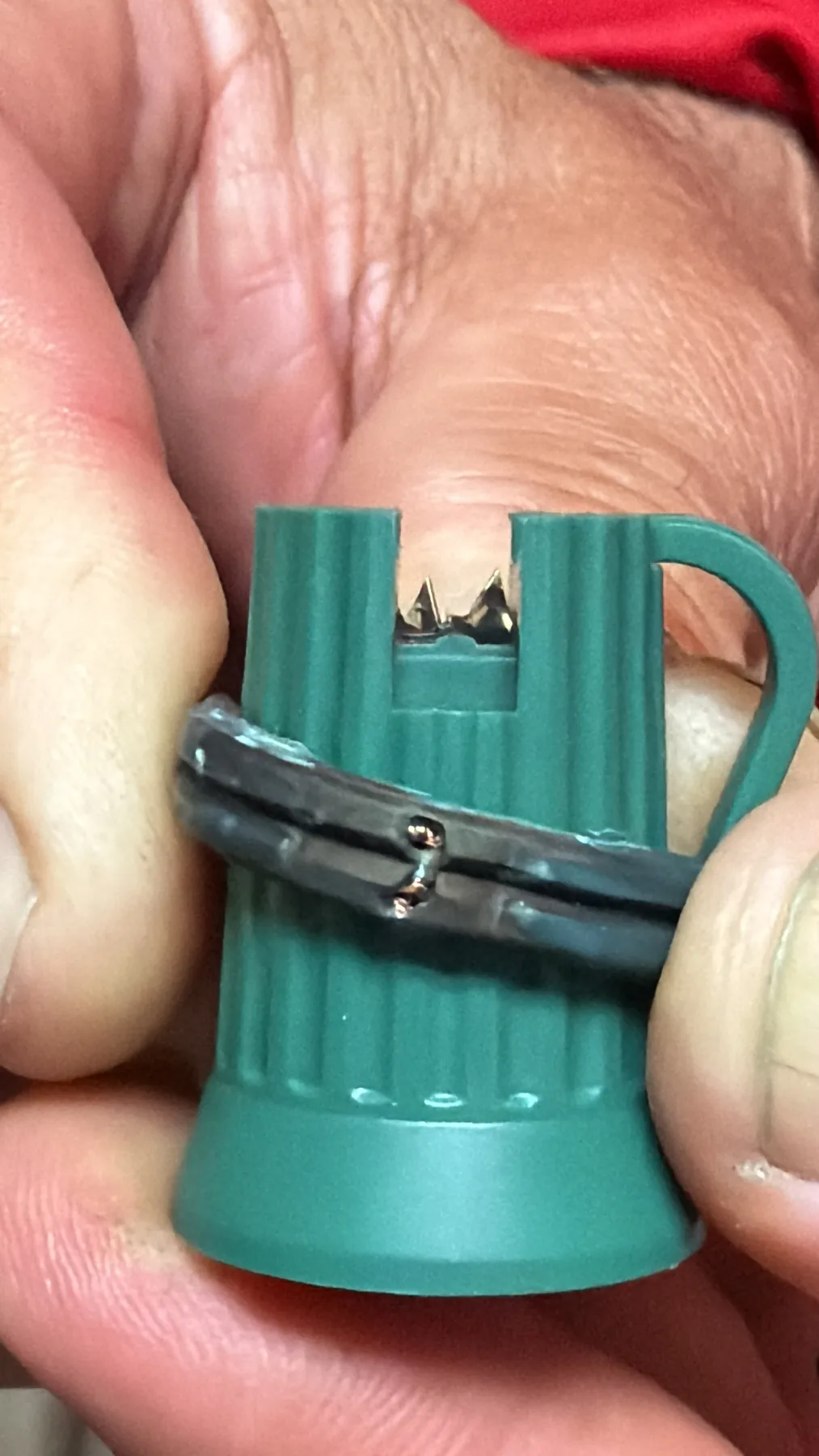 Close view of C9 socket contact prongs engaging green flat wire