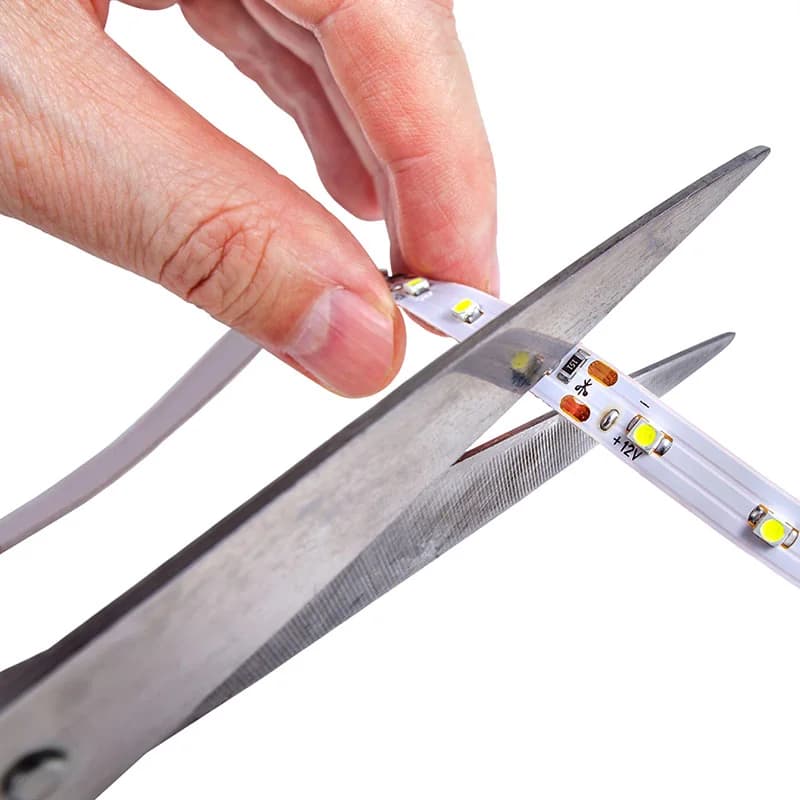 LED strip being cut precisely at the marked cut point
